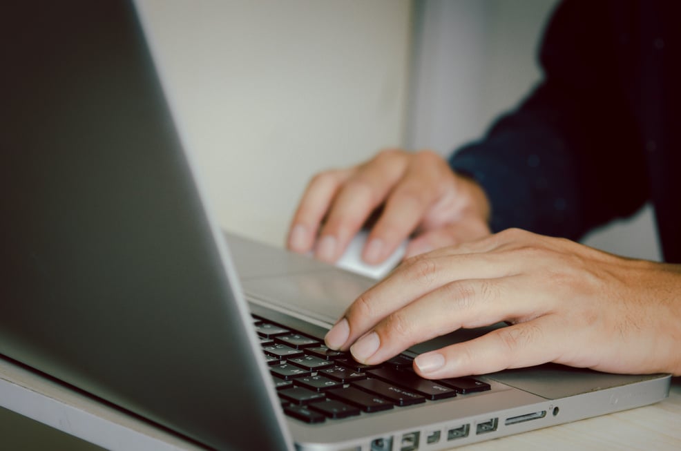 Man Hand Using a Computer to Type on a Keyboard to Find Informat